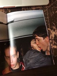 an open book with pictures of people in the back seat and on top of it