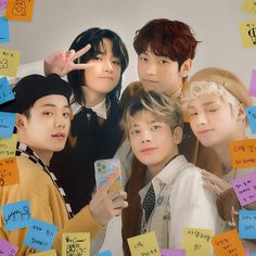 the group of young men are posing for a photo with sticky notes all over them