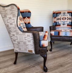 two chairs sitting next to each other on top of a hard wood floored floor