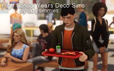 a young man holding a tray with food on it in front of two girls and one boy