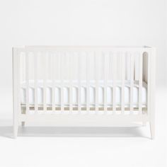 a white crib is shown against a white background with no sheets on the bed