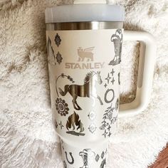 a white travel mug sitting on top of a rug