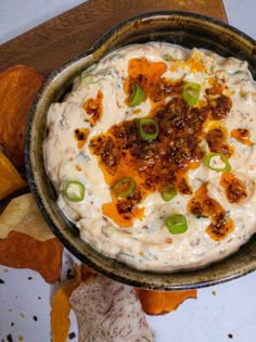 a bowl filled with dip surrounded by chips