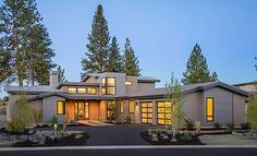 a large house with lots of windows and trees