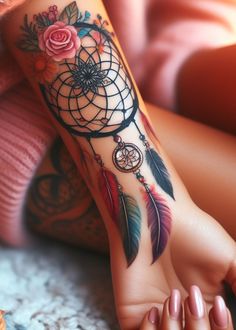 a woman's foot with a dream catcher tattoo on her left leg and pink roses in the background