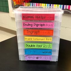 a stack of plastic containers filled with different types of sight words on top of a table