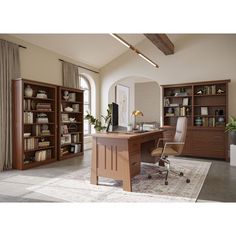 an office with bookcases, desk and chair