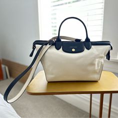 Original Bi-Color Sample Bag From The First Year Of Le Pliage Heritage. A Celebratory Elevation Of Longchamp's Iconic Le Pliage Bag. In Excellent Condition, Some Softening Of Leather On The Right Side. White Bags With Leather Trim For Formal Occasions, White Formal Bag With Leather Trim, White Leather Trim Formal Bag, Formal White Bags With Leather Trim, Luxury White Bag With Leather Trim, Timeless White Bags With Leather Handles, Luxury White Bags With Leather Trim, Longchamp Bags, Color Samples