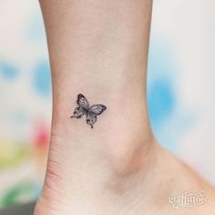 a small butterfly tattoo on the ankle