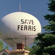 a large white water tower with the words save ferriss on it's side