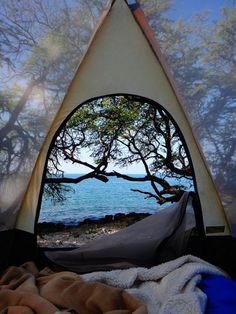 the view from inside a tent looking out at water