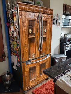 an old fashioned wooden refrigerator in a kitchen