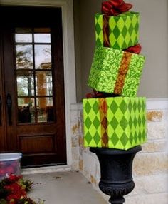 three wrapped presents are stacked on top of each other in front of a door way