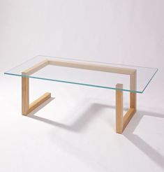 a glass table with wooden legs on a white background