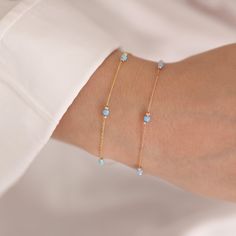 Enhance your look with this 14k Gold Light Blue Opal Round Bracelet, which comes in three opal colors: immaculate white opal, peaceful light blue opal, and intriguing dark blue opal. Each opal represents October's birthstone and possesses distinct characteristics, making this bracelet an ideal birthday gift or accessory for Libras.  This bracelet oozes elegance and grace because to its link to Venus, the goddess of love and beauty. Choose the light blue opal for a quiet and soothing impression, Light Blue Gemstone Bracelets As Gift, Blue Birthstone Bracelets In Fine Jewelry Style, Blue Birthstone Bracelets Fine Jewelry, Dainty Blue Gemstone Bracelets, Dainty Blue Gemstone Bracelet, Fine Jewelry 14k Gold Blue Bracelets, Fine Jewelry Blue Bracelets, Minimalist Blue Jubilee Bracelet, Blue Minimalist Jubilee Bracelet