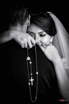 the bride and groom are posing for a black and white photo