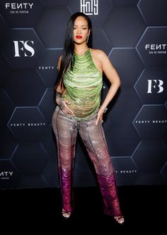 an image of a woman posing on the red carpet in front of a black background