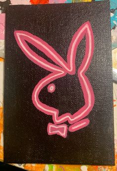 a painting of a pink rabbit on black