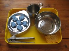 a yellow tray with silver pans and other items on it, including an oven mitt