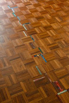 a wooden floor that has some tape on it