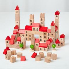 a group of wooden blocks with red roofs