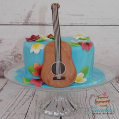 a blue cake with a guitar on top