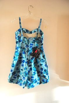 "Mod vintage 60s, pastel blue , stretched , sculptured body, one piece swim suite with an abstract blue poppy's print. Made by Alix of Miami ( Florida's first name in American fashion) of 66% acetate, 44% cotton, 10% rubber. No, bones, no wires, no \"corseted-in \" feeling. Adjustable straps. Boy's cut bottom with a white nylon, bloomers lining. Closure on the back with a blue metal zipper. White cotton, soft lined cups. Awesome. Mint condition. With the original tags. Never used. Very clean ins Retro Blue Printed Swimwear, Retro Blue Lined Swimwear, Vintage Blue Swimwear For Summer, Retro Fitted Blue Swimwear, Blue Fitted Retro Swimwear, Fitted Retro Blue Swimwear, Fitted Light Blue Floral Print Swimwear, Vintage Blue Swimwear For The Beach, Vintage Blue Swimwear For Swimming