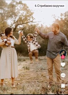 a family holding hands and walking through the woods