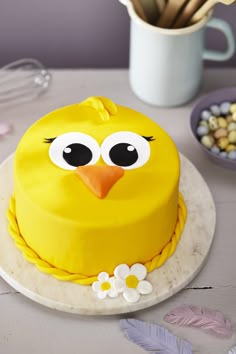 a yellow cake decorated with an angry bird face