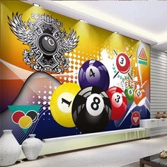 a room with pool balls on the wall and an artistic mural in the corner behind it