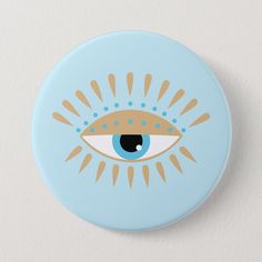 a blue button with an eye and sunbursts on the front, against a white background