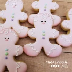 several decorated cookies sitting on top of a wooden table