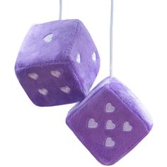 two purple dices with hearts hanging from strings