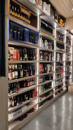 the shelves are filled with many different types of alcohol