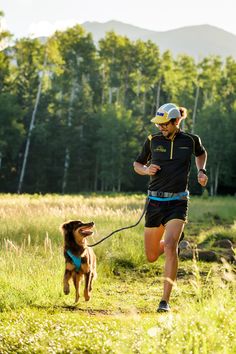 a man running with his dog on a trail