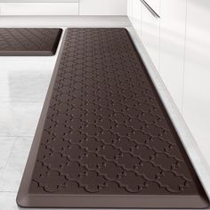 two brown mats in the middle of a kitchen floor