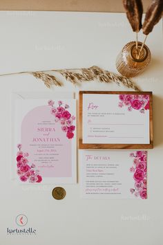 wedding stationery with pink flowers and feathers