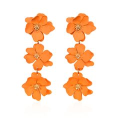 an orange flower earrings on a white background