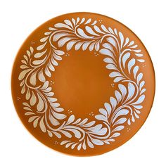 an orange plate with white designs on it