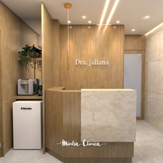 the interior of a dental office with wood paneling and marble counter tops, along with a white refrigerator