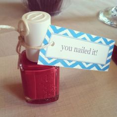 a bottle of nail polish sitting on top of a table next to a sign that says you nailed it