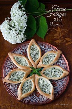 some food is sitting on a plate next to flowers