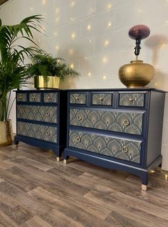 two blue dressers sitting next to each other on top of a hard wood floor