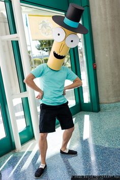 a man standing in front of a building with a paper cut out of him wearing a top hat