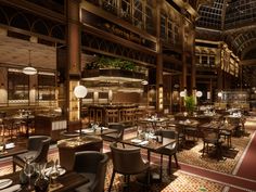 the interior of a restaurant with tables and chairs