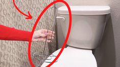 a woman is trying to open the lid of a toilet with an arrow pointing at it