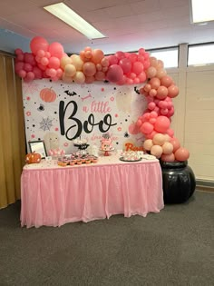 the table is set up with balloons and desserts