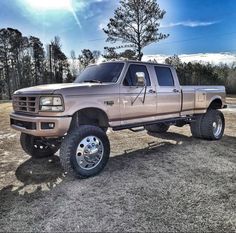 a large truck parked on top of a dirt field