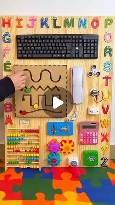 a child's play area with a keyboard, mouse and various toys on it