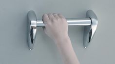 a person is holding onto the handle of a door